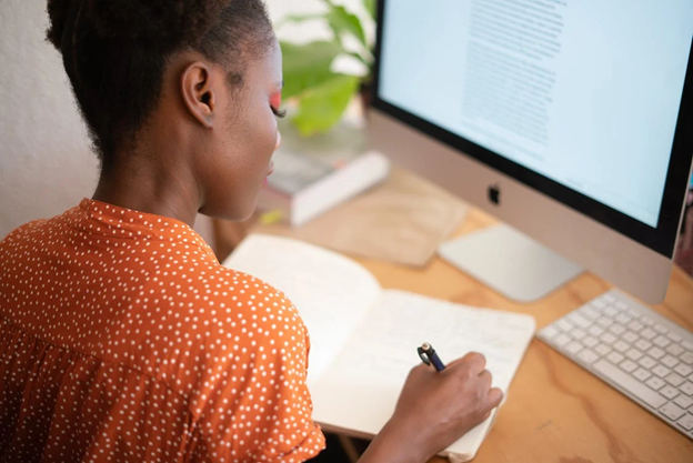 A woman writing in a notebook